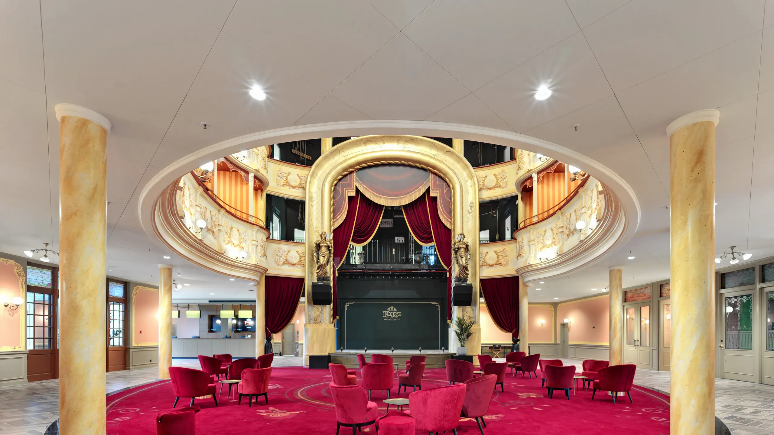 White hotel ceiling design at the auditorium and Lobby of Plopsa hotel in De Panne Belgium with Rockfon Color-all Stucco in D-edge