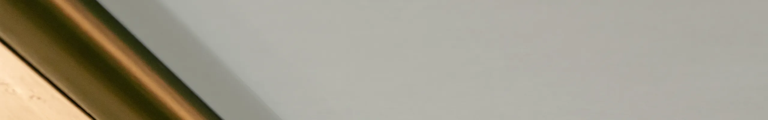 Colorful ceiling with large horizontal stripes in red, blue, green, and beige tones, intersected by a dark, diagonal beam.