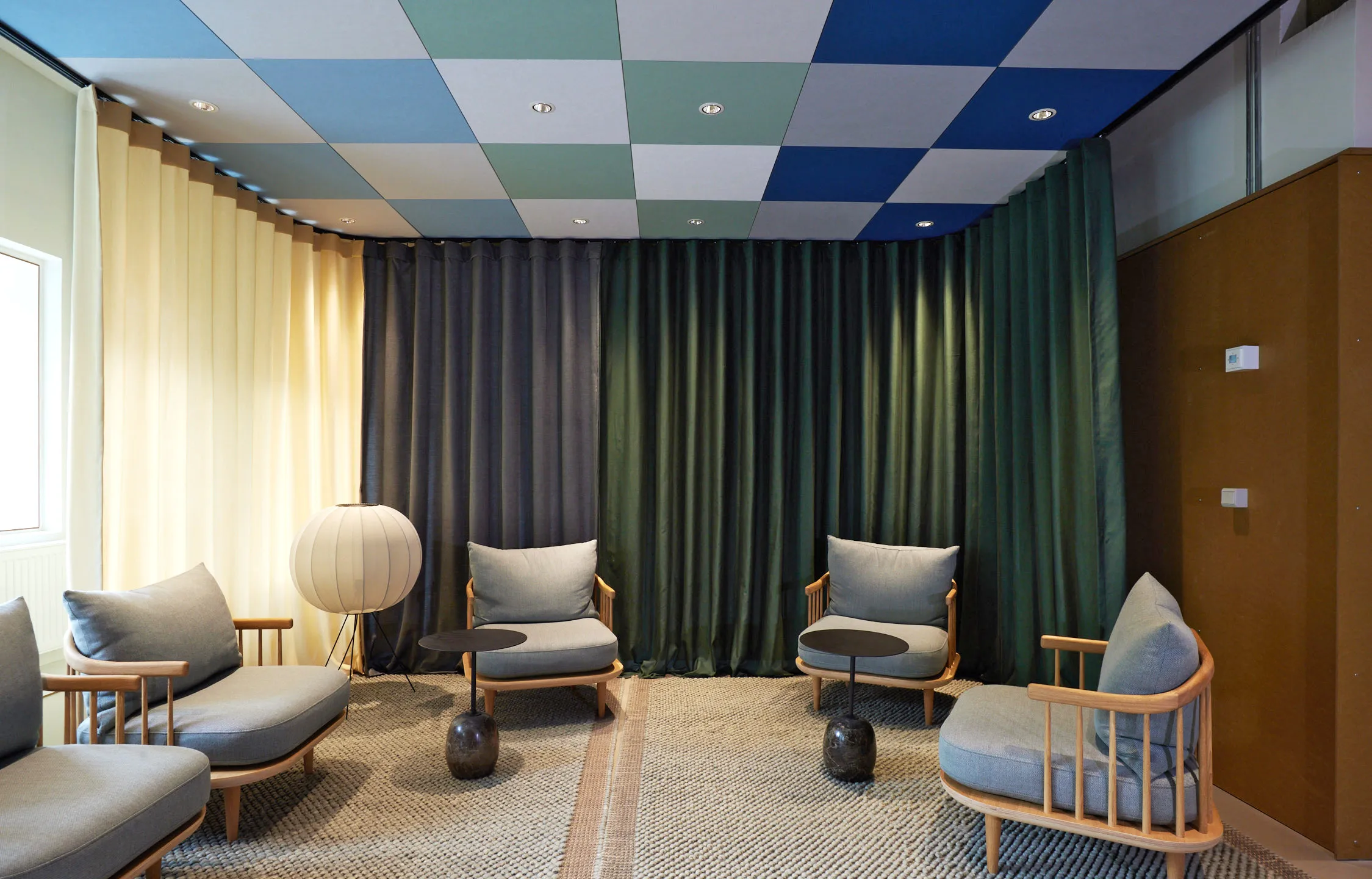 A checkered ceiling design with rich colours and greys.