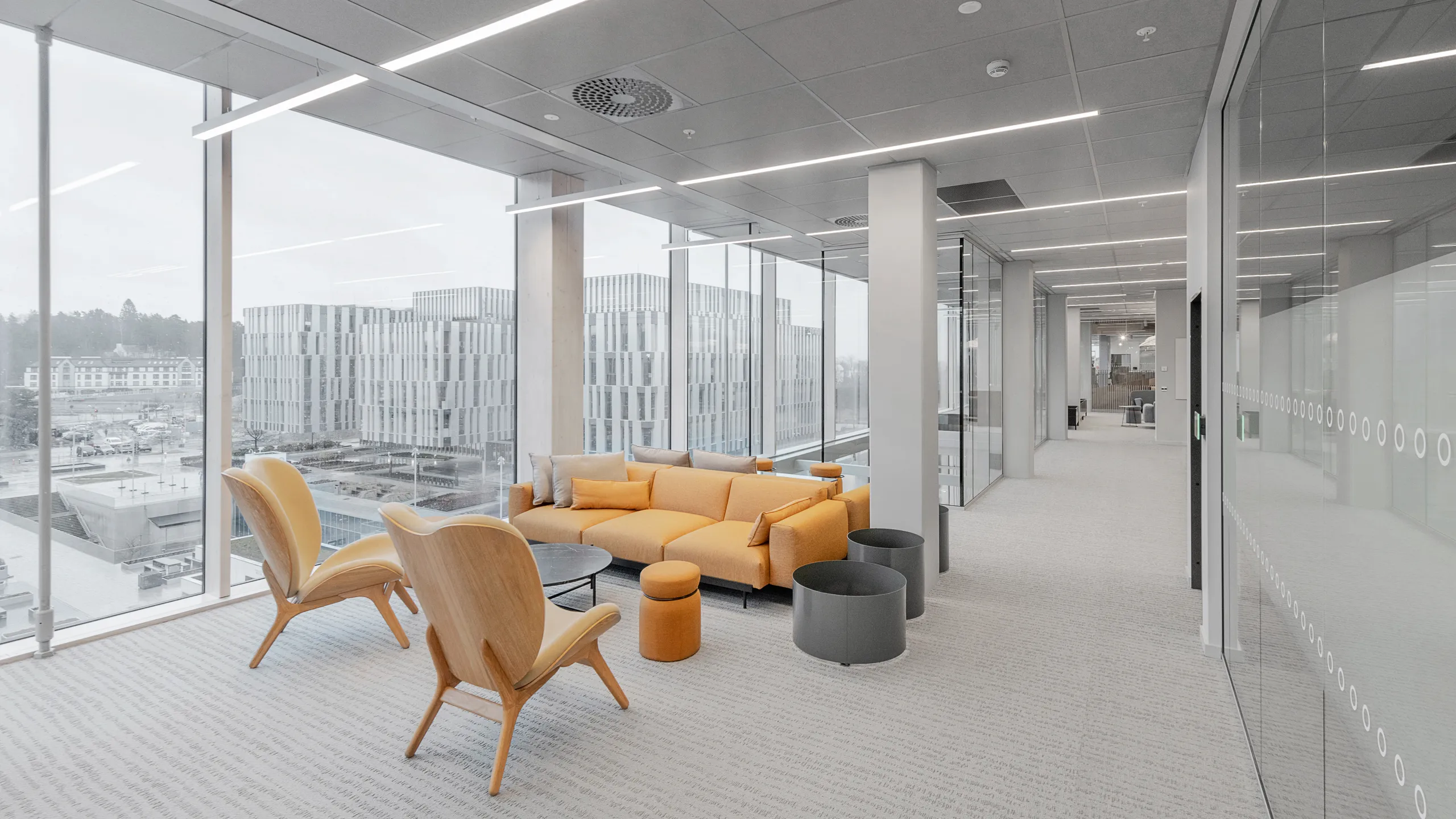 Grey ceiling tiles are an office breakout space