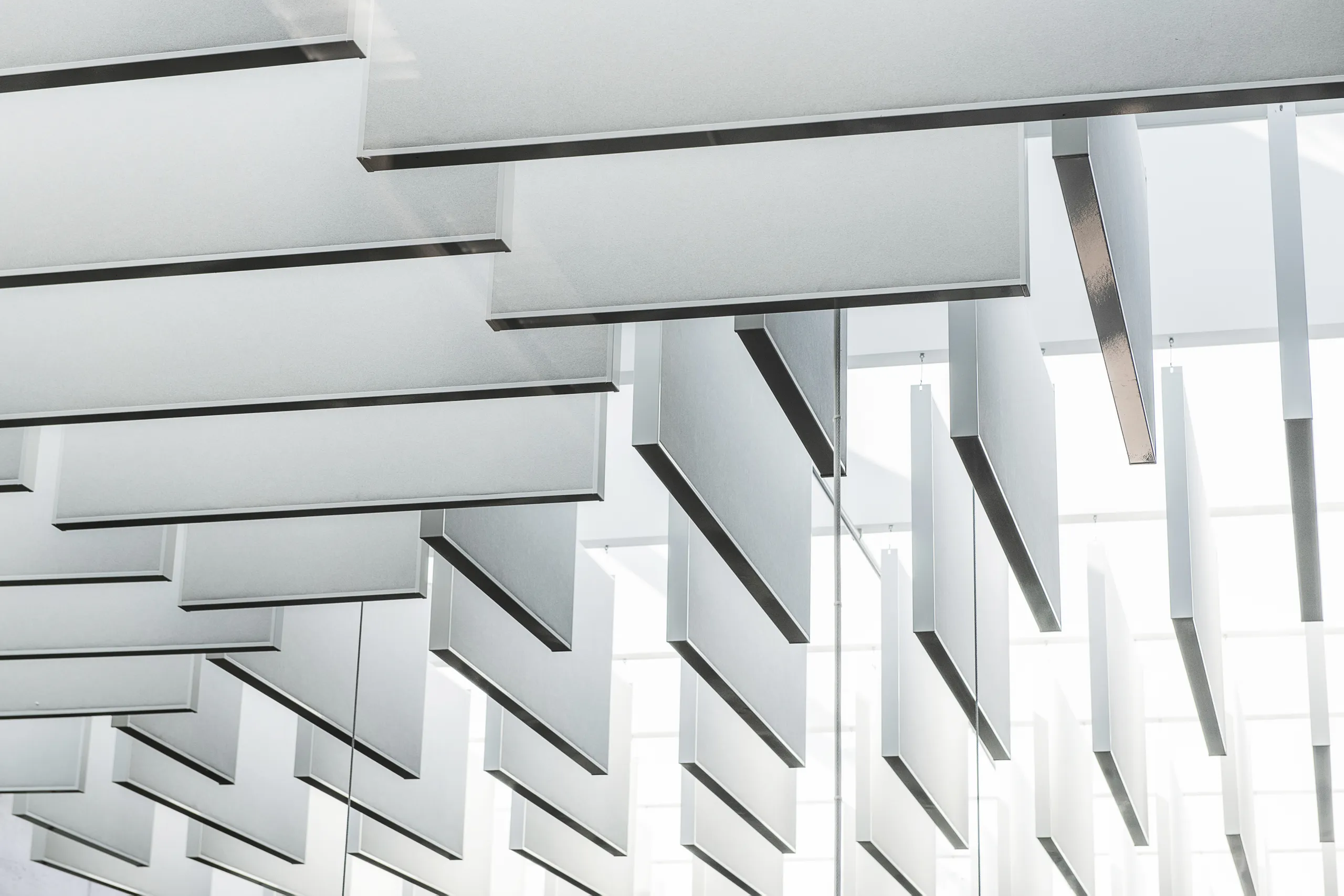 Detail view of Rockfon acoustic floating ceiling panels and suspending ceiling clouds or islands.