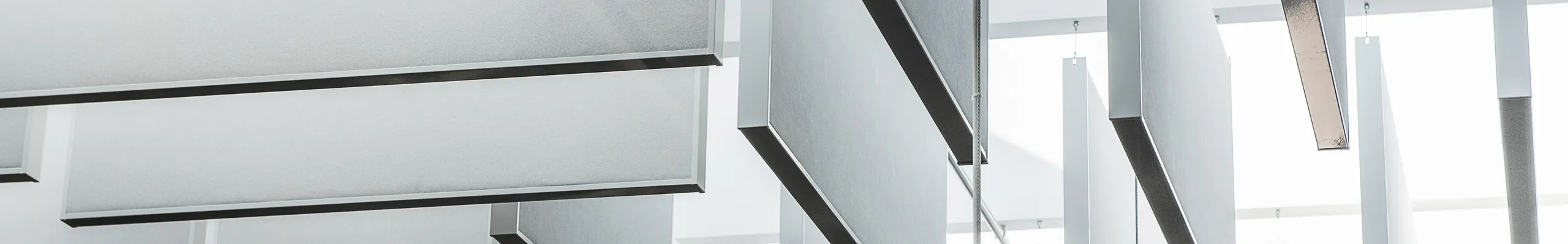 Detail view of Rockfon acoustic floating ceiling panels and suspending ceiling clouds or islands.