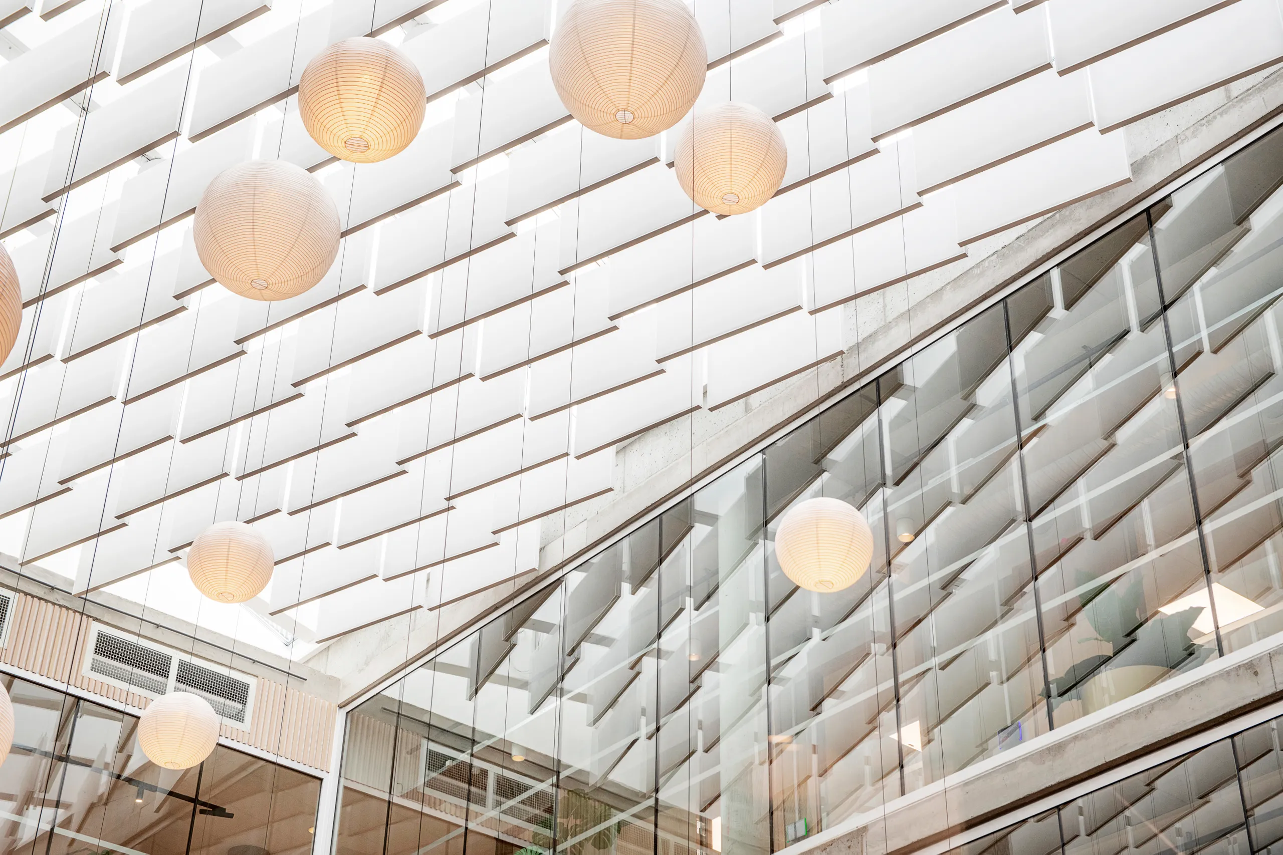 Alo office building with Rockfon baffles and ball pendant lights