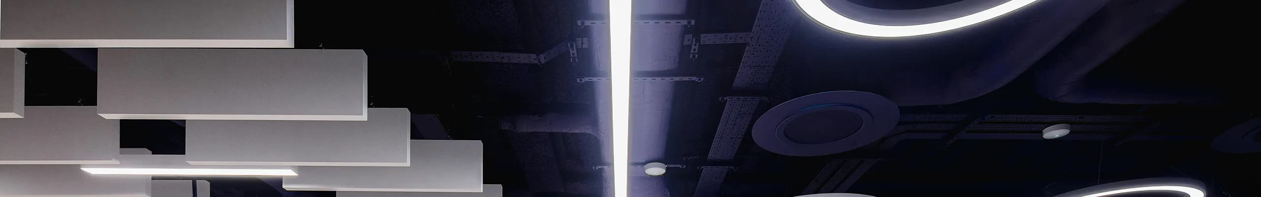 Modern open office with ceiling-mounted acoustic baffles and round acoustic islands, combining lounge seating, shared tables, and linear lighting under a dark exposed ceiling