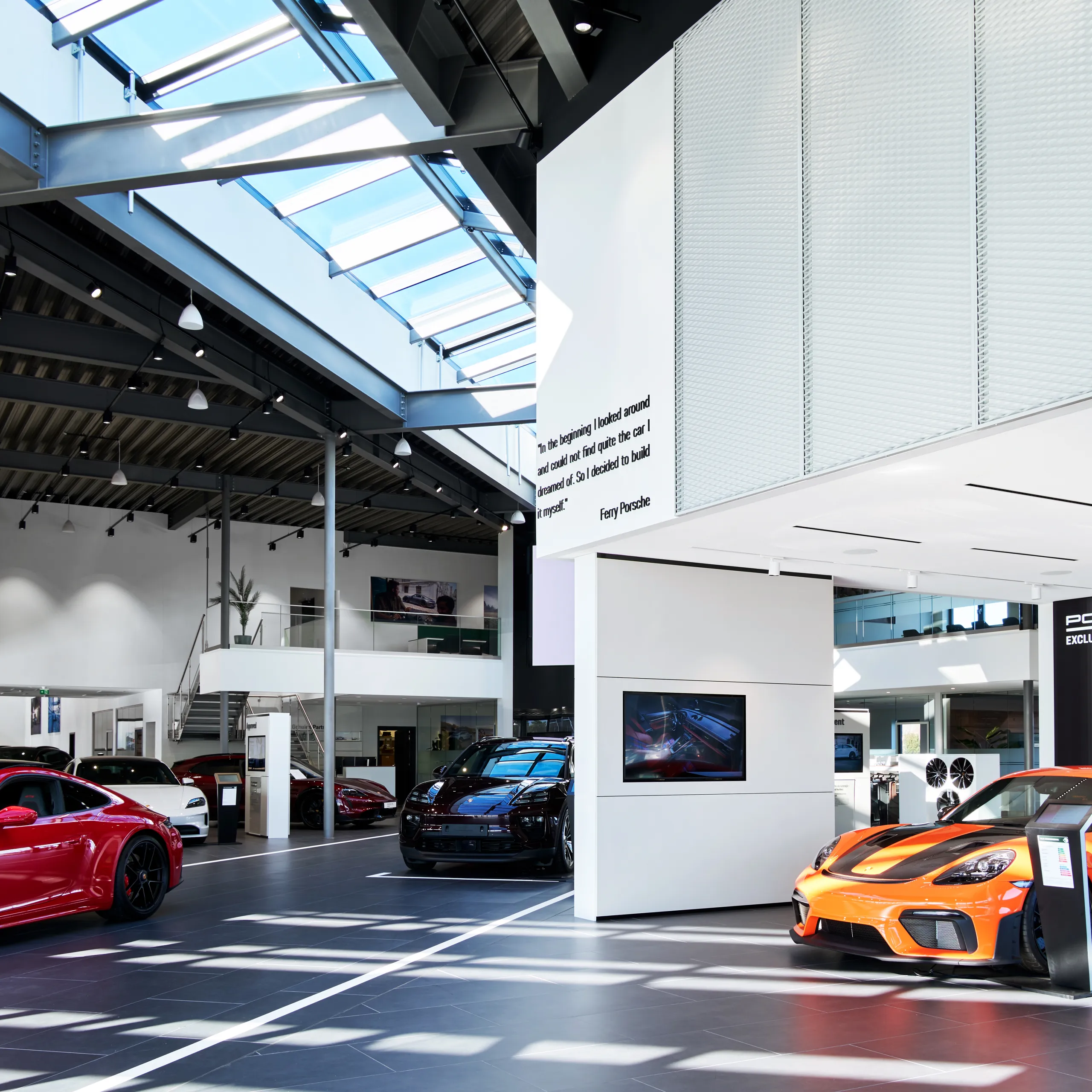 A Porsche Center in Norway with Rockfon Mono Acoustic ceilings that manage the high levels of reverberation caused by the cars on show.