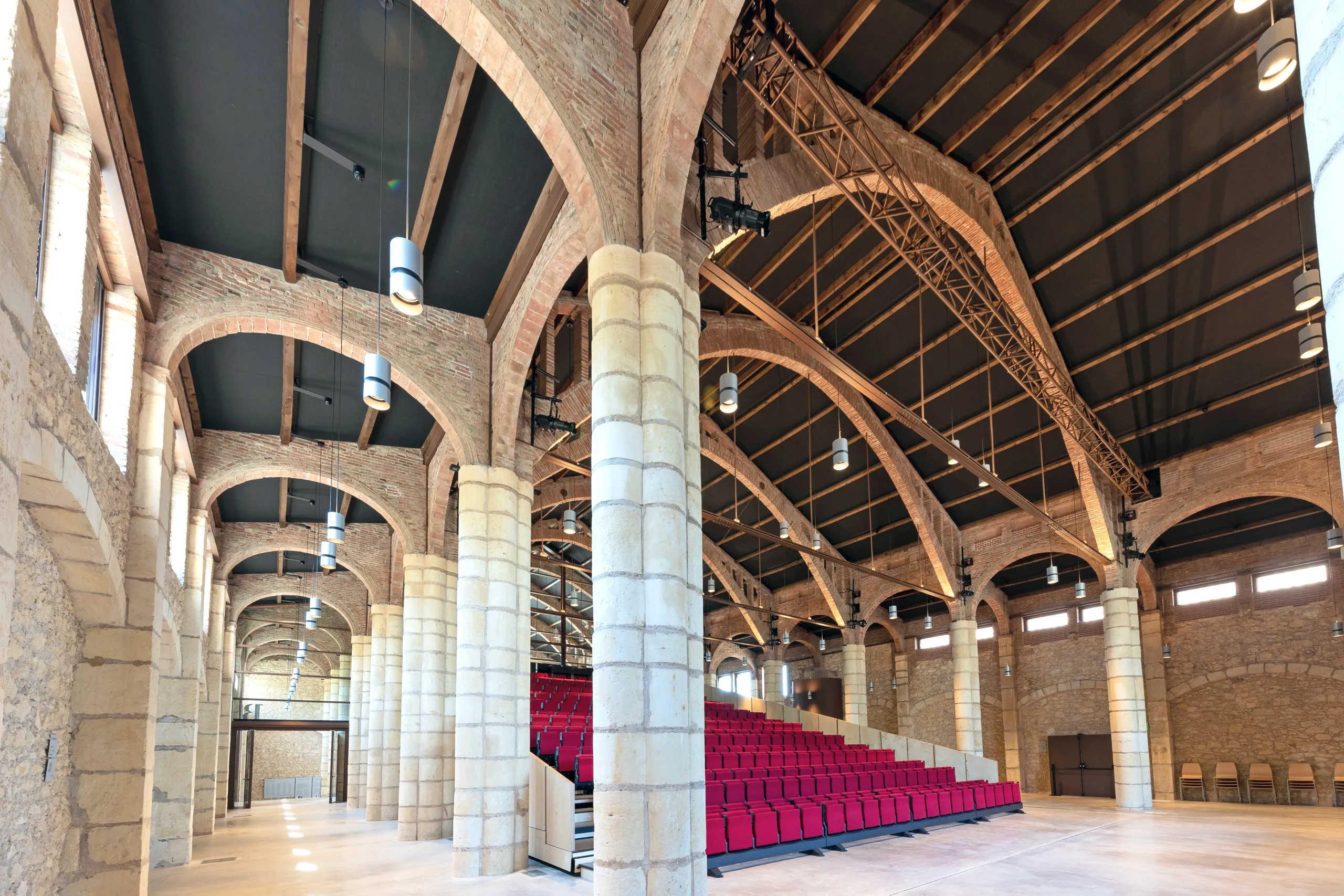 Interior of Celler de Vila-seca featuring vaulted timber ceilings with Rockfon Color-all acoustic panels in Charcoal for museum acoustics