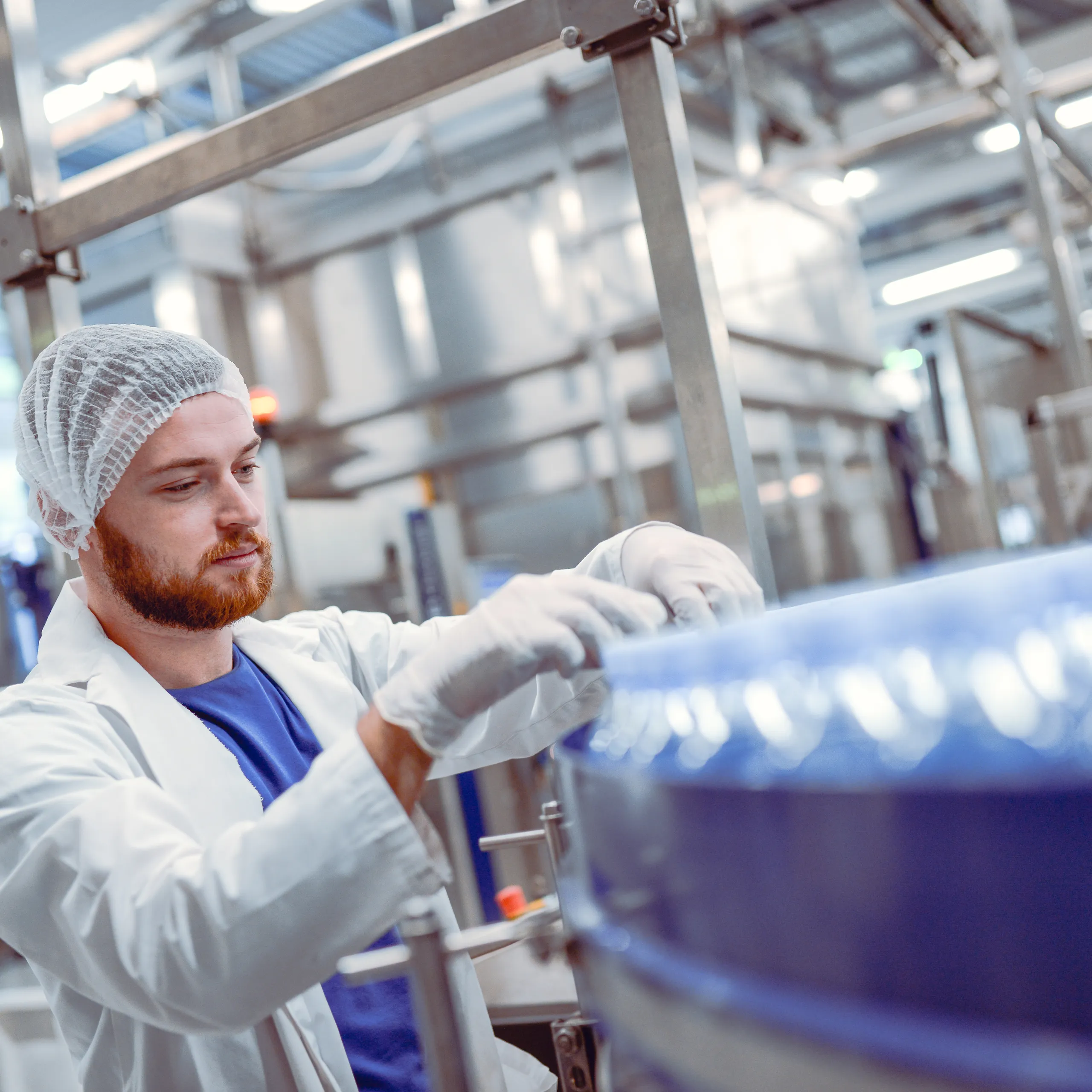 A production facility with optimised acoustics using acoustic ceiling tiles and a ceiling grid.