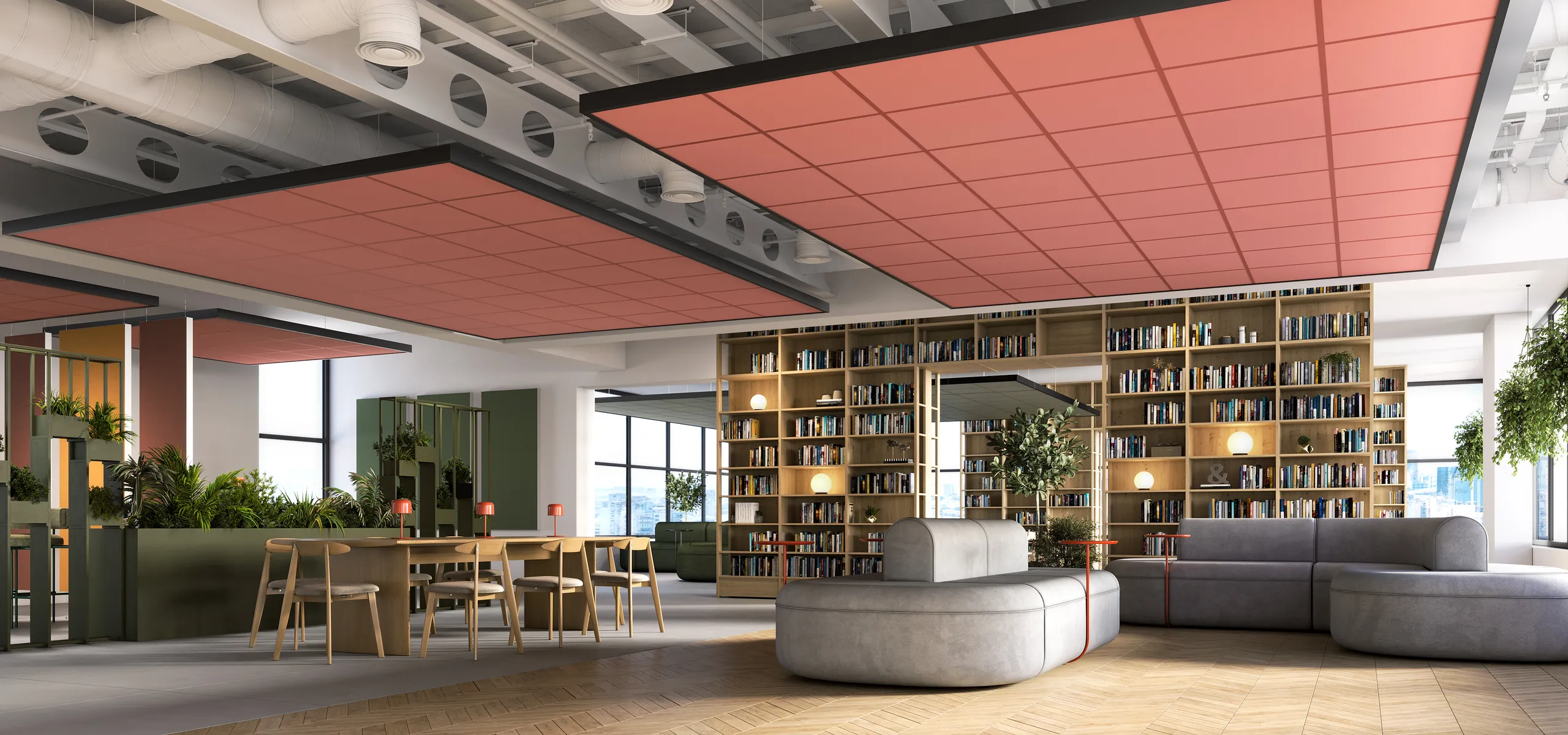Open office lounge and library space with bookshelves, seating areas, and large suspended red acoustic ceiling panels beneath exposed ductwork and services.