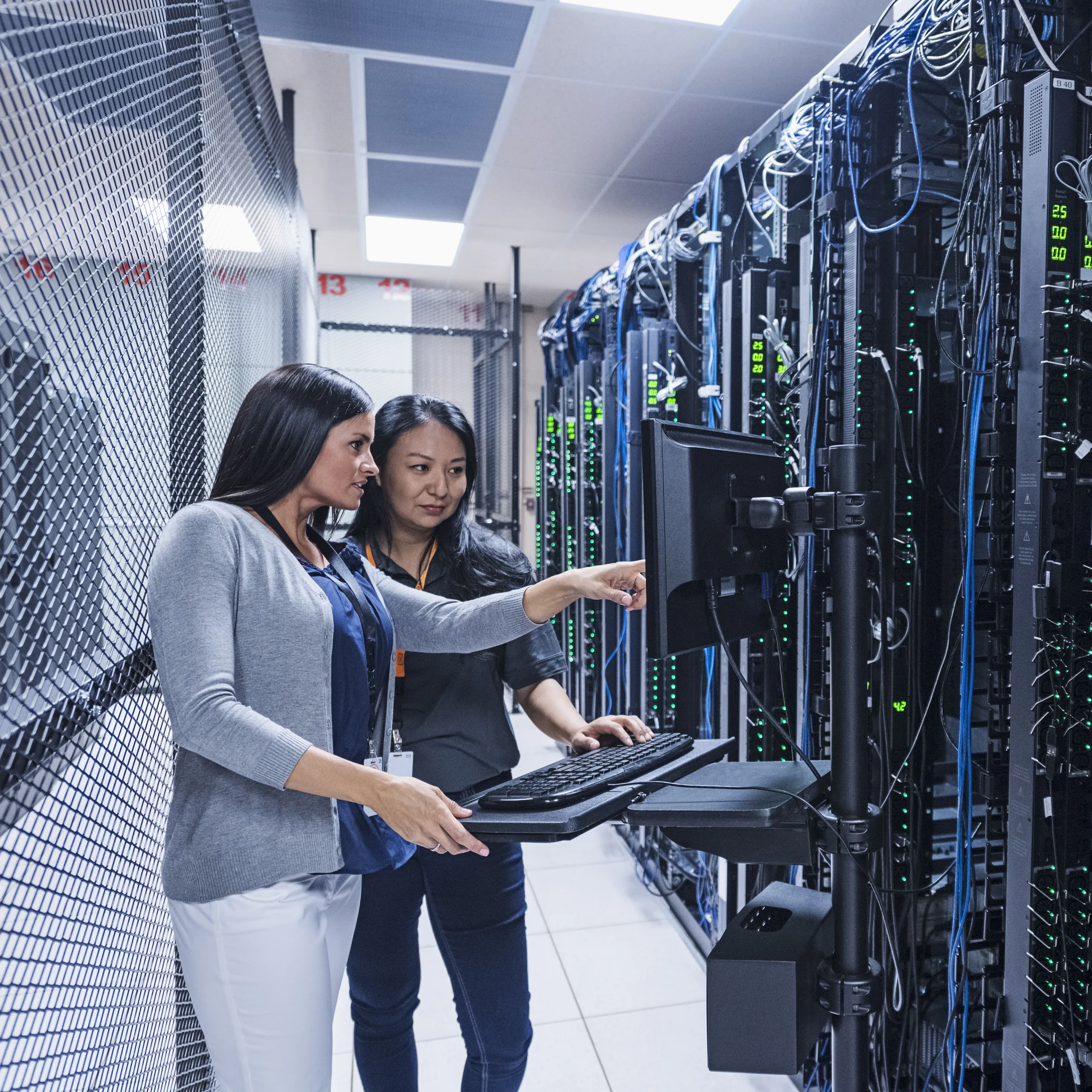 A data centre with optimised acoustics using sound insulation ceiling tiles and a ceiling grid.