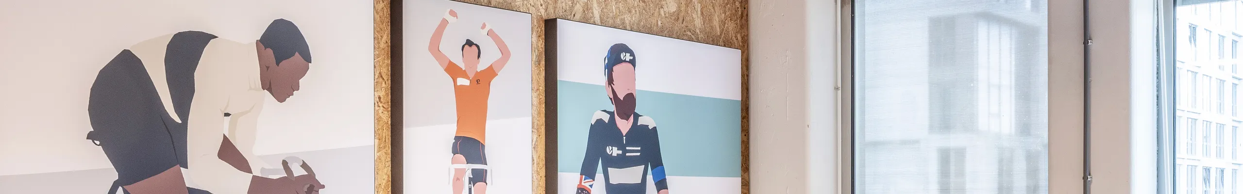 Meeting room with spray-applied acoustic ceiling absorber and acoustic wall panel, pendant lighting, and a long wooden table surrounded by black office chairs